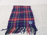 a close up of a blue and red plaid scarf on a white surface