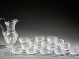 a lot of glasses and a pitcher sitting on a table