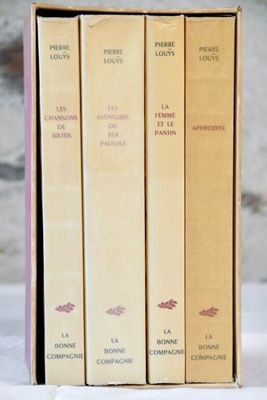 three books in a box on a table with a white background