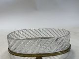 a glass bowl with a metal base on a table
