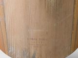 a large wooden vase that is on a white surface