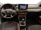 the interior of a small car with a steering wheel and dashboard