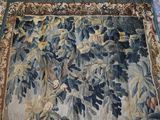 a rug with a picture of a tree and birds on it