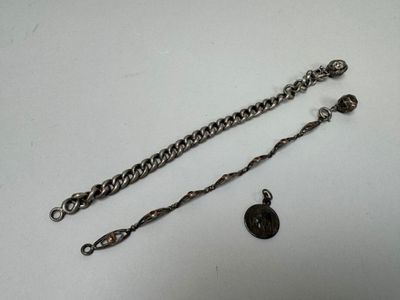 a silver chain with a black button attached to it