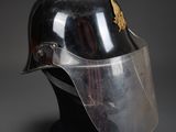 a close up of a metal helmet with a clear vise