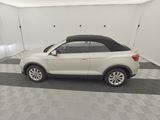 the white volkswagen suv is parked in a clean garage