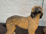 a figurine of a dog on a table next to a lamp