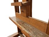 a wooden bench that is sitting in front of a window