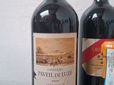 two bottles of wine are sitting next to each other on a table