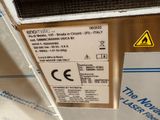 a label on the back of a machine that is sitting on a table