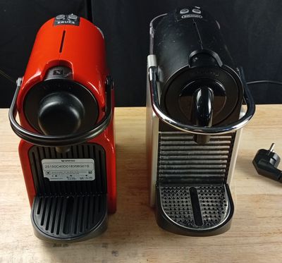 two coffee machines that are sitting on a table