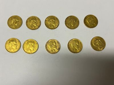 a bunch of gold coins sitting on top of a white surface