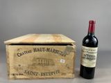 an old wooden box with a bottle of wine next to it