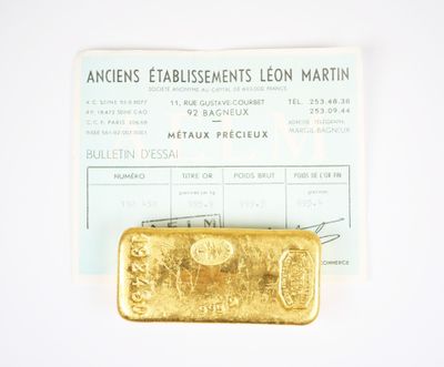a gold bar sitting on top of a piece of paper