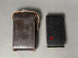 two cell phones sitting next to each other on a table