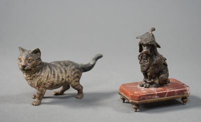 pair of bronze figurines of a cat and a dog on a cushion