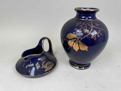 a blue vase and a small blue vase on a table