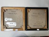 two framed pictures on the wall with writing on them