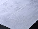 a close up of a white table cloth on a black table