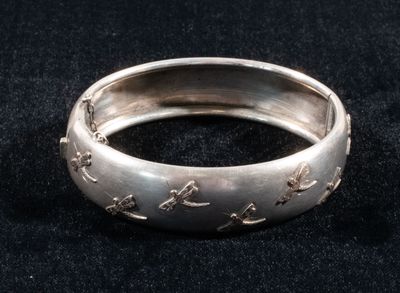 an image of a close up of a silver ring on a black surface