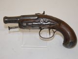 an old gun that is on display on a white surface