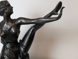 bronze statue of a woman holding a ballerina on a marble base