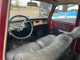 a red truck with a steering wheel and a dashboard
