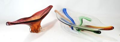 two glass bowls sitting next to each other on a white surface