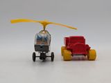 a toy helicopter and a toy car next to each other