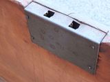 a close up of a piece of metal on a wooden bench