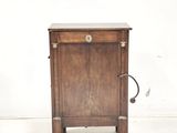 a small wooden cabinet with a door and a drawer
