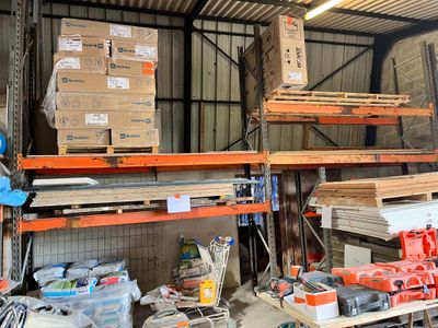 many boxes and tools on the shelves in the warehouse