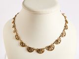 gold plated necklace with heart charms on a white mannequin
