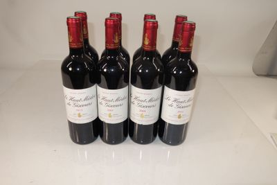 four bottles of wine are lined up on a counter
