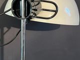 a white lamp that is on a stand on the wall