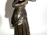 bronze statue of a woman with her hand on her face