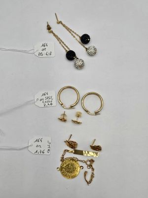 a close up of a bunch of jewelry on a white surface