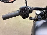 a close up of a motorcycle handlebar with a mirror