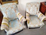 two chairs that are sitting next to each other in a room