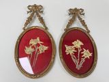 une paire de cadres ovales rouges et dorés ornés de fleurs