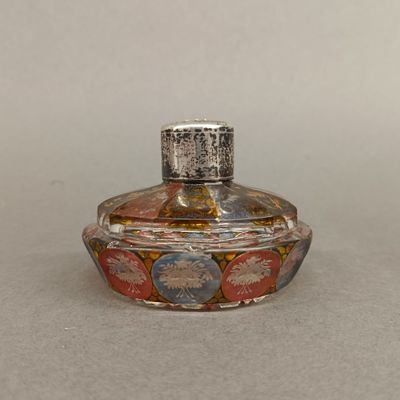 a small glass bottle with a lid on a table