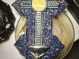 a blue and yellow cross on a plate on a table