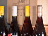 several bottles of wine are lined up on a table
