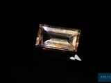a close up of a diamond on a black surface