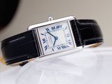 a close up of a wrist watch on a white surface