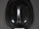 a close up of a toilet with a black lid