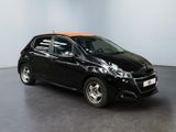 the small black car is parked in a large room