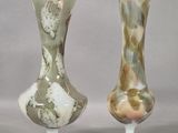 two vases sitting side by side on a table