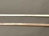 two old swords are laying on a table next to each other