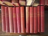 several old books are stacked on top of each other on a table